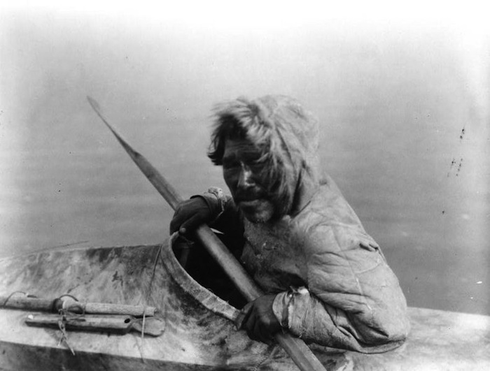 man in skin kayak with paddle and spear.jungian therapy