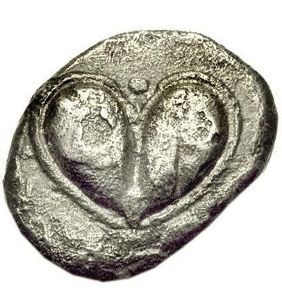 Ancient silver coin with heart symbol. Jungian analysis